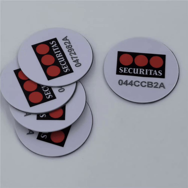 แท็กเหรียญ PVC RFID แบบพิมพ์ที่มีแบรนด์ Securitas และรหัสซีเรียล แสดงการระบุตัวตนเพื่อการควบคุมทรัพย์สินอย่างปลอดภัย