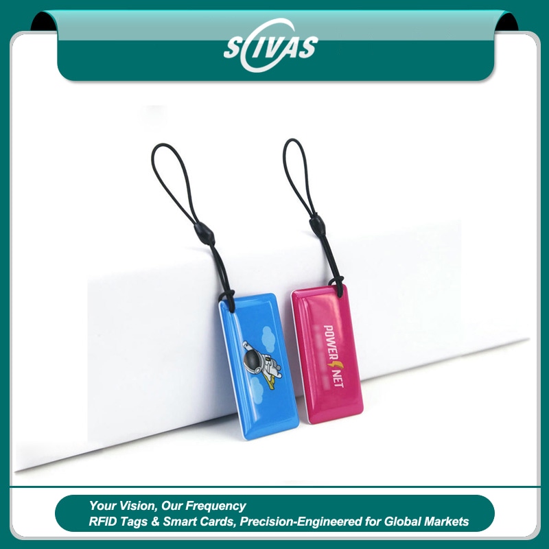 ภาพที่ 1: ภาพนี้แสดงพวงกุญแจ RFID พิมพ์ลายสำหรับทางเข้า ลงเวลา และสมาชิก โดยเน้นอีพ็อกซี และการทำงานรวดเร็ว สำหรับการควบคุมการเข้าออก.